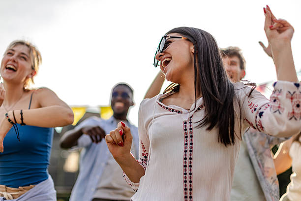 istock Excited crowd dances joyfully at popular outdoor concert during sunset 2219497167