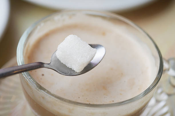 istock Sweetening a warm beverage with a sugar cube at a cozy cafe 2219497471