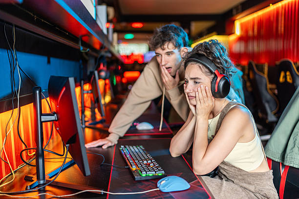 istock Worried gamers watching screen in internet cafe 2219498463