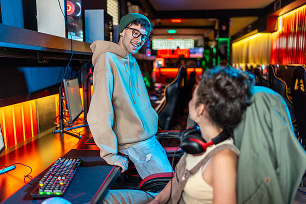 istock Gamers playing and chatting in internet cafe 2219498786