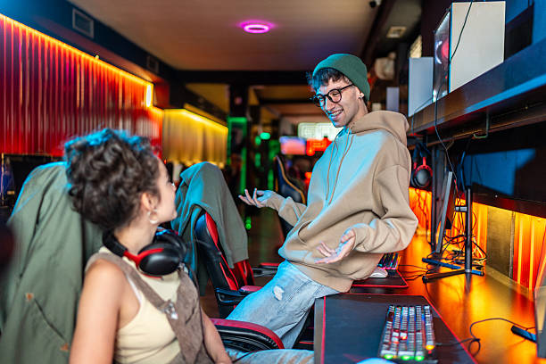 istock Gamers playing and chatting in internet cafe 2219499114