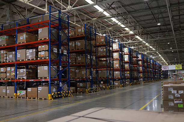 istock Digital tablet or laptop with white screen for job operating in High rack warehouse , logistic management and technology 2219499884