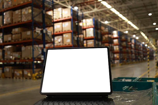 istock Digital tablet or laptop with white screen for job operating in High rack warehouse , logistic management and technology 2219499886