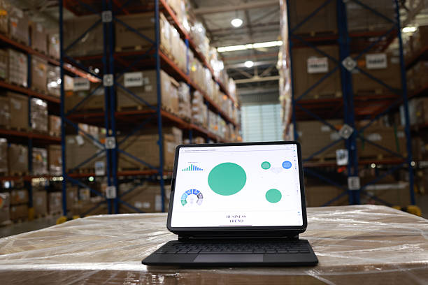 istock Digital tablet or laptop with white screen for job operating in High rack warehouse , logistic management and technology 2219499888