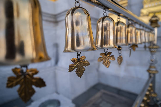 Golden Buddhist bell hanging in a row
