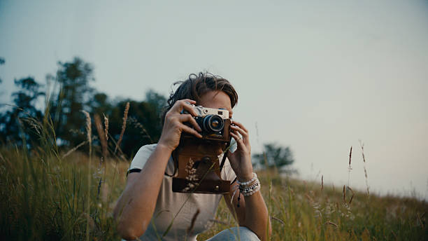 istock Woman Photographing,Using Retro Camera On Rural Grassy Hillside 2219502625