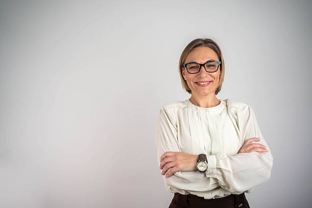 istock Happy mature woman smiling on grey wall 2219505292