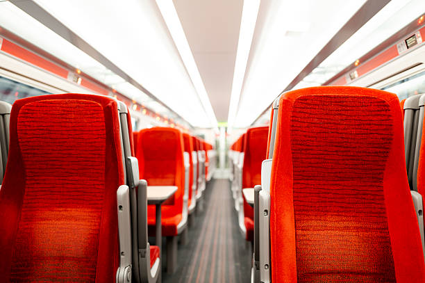 Shallow focus of passenger seating seen within a clean, British passenger train. stock photo
