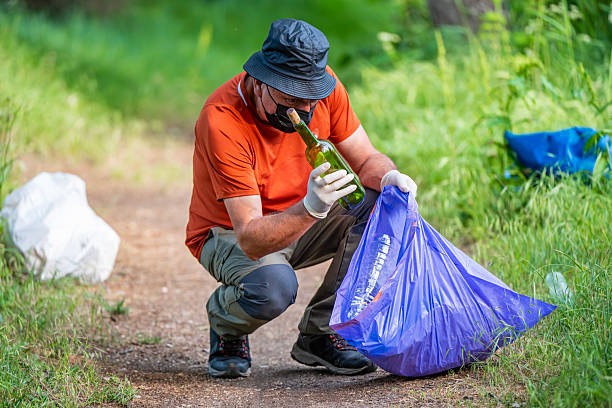 istock Volunteer environmentalist collecting trash in the forest, environmental cleanup 2219505521