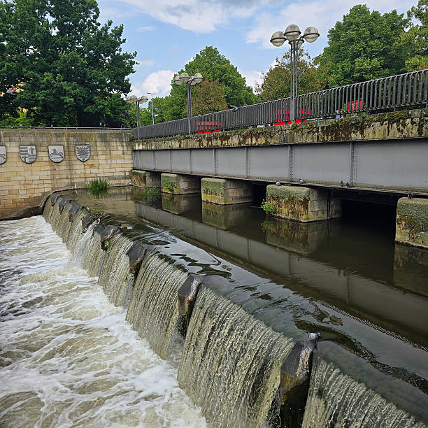 istock A Beautiful Scenic Waterfall Flowing Gracefully Under a Bridge in a Lively Urban Environment Hannover 2219505867