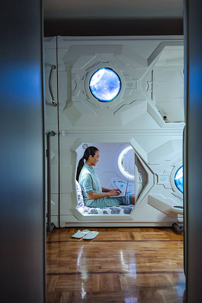 istock Person working in illuminated futuristic compact pod interior with technology 2219509328