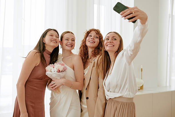 istock Multiethnic Young Women Smiling and Posing for Selfie during Wedding Celebration 2219510128