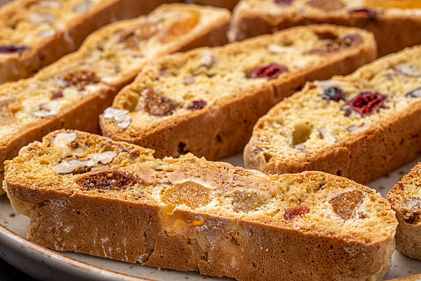 istock Italian Almond Biscotti biscuits in a rustic home made pottery bowl. Studded with almonds and cranberries, these twice-baked treats are aromatic and inviting. Ideal. 2219512511