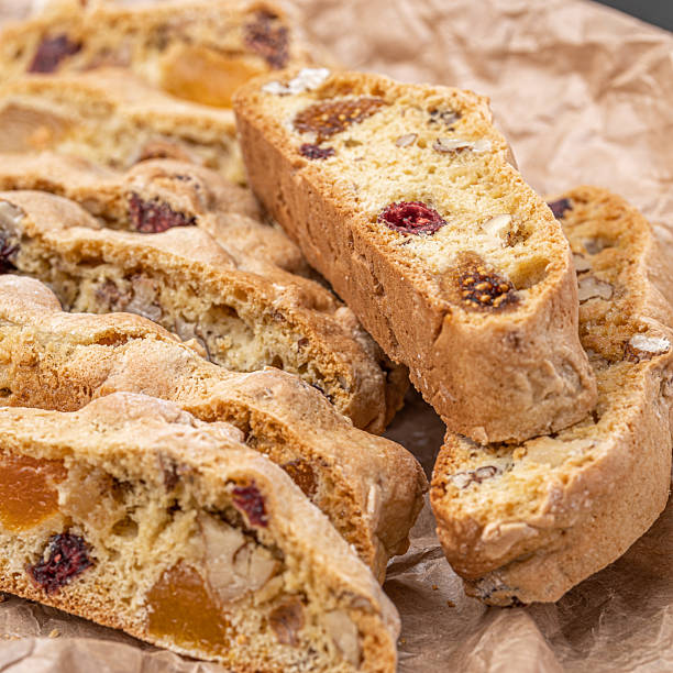 istock Italian Almond Biscotti biscuits in a rustic home made pottery bowl. Studded with almonds and cranberries, these twice-baked treats are aromatic and inviting. Ideal. 2219512513
