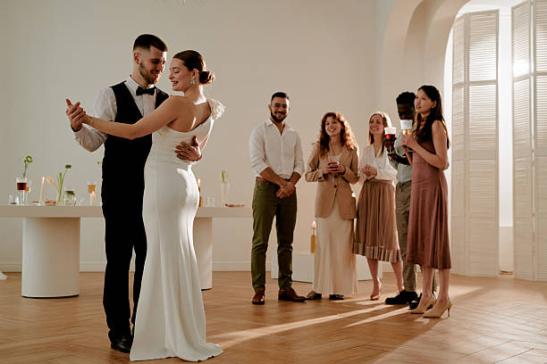 istock Young Caucasian Couple Dancing Together While Diverse Friends Watching Wedding 2219513498
