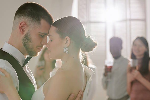 istock Young Caucasian Couple Dancing Embracing during Wedding Celebration Indoors 2219513499