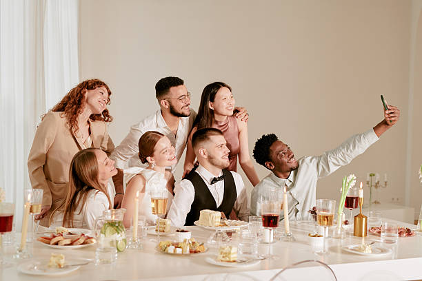Diverse Group of Young Adults Smiling and Taking Selfie during Wedding Celebration