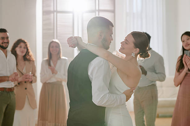 istock Young Caucasian Bride and Groom Dancing Surrounded by Diverse Wedding Guests 2219513672