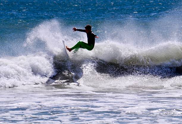 istock Surfer on a Wave with Spray Flying 2219513853