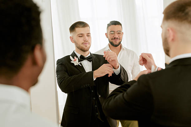 istock Young Caucasian Man Adjusting Cufflinks with Multiethnic Friends Preparing Wedding 2219514879