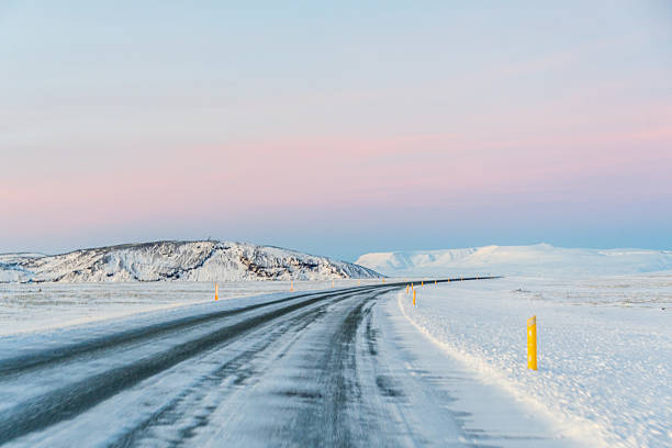 An icy road on a beautifully sunny winter afternoon in Iceland.