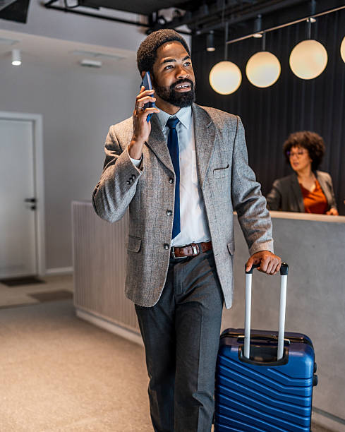 istock Businessman talking on phone at hotel reception 2219517060