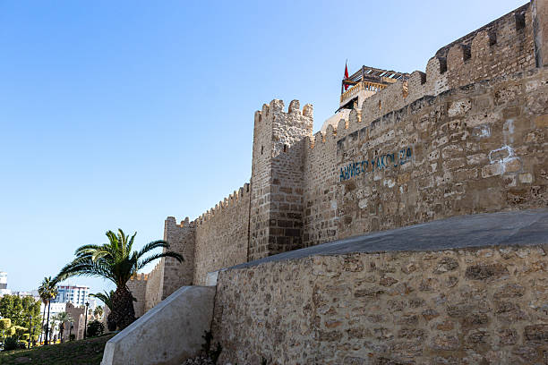 istock A stone fortress stands tall against a clear blue sky. 2219519542