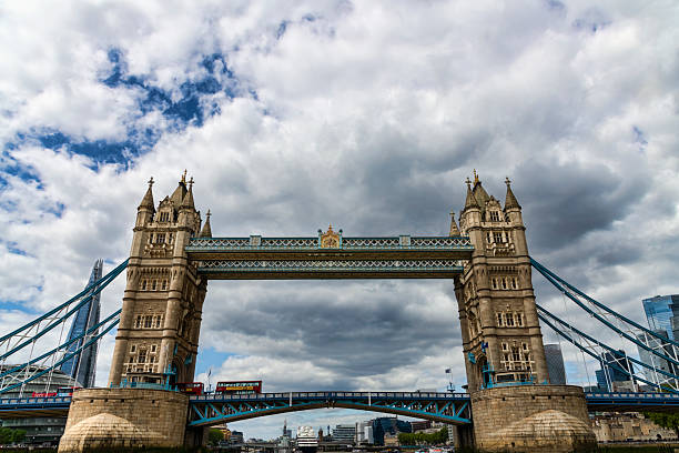 London, England, UK - May 4, 2025:  Iconic Tower Bridge, red double decker bus, and the Shard in the City of London, UK.