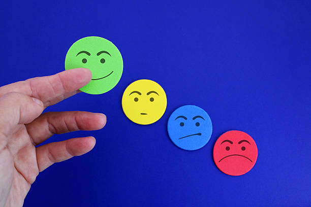 istock Hand selecting a happy face among others with different moods 2219525159