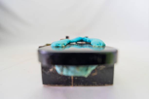 Photo of a model cruise ship in a rusty metal tin.