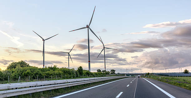 istock Wind turbines along road. Wind generation. Eco landscape 2219527326