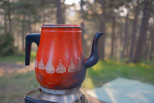 Old gilded kettle on an iron stove