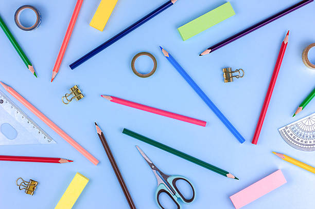 istock edukation background - colored different stationery on blue background, top view 2219529208