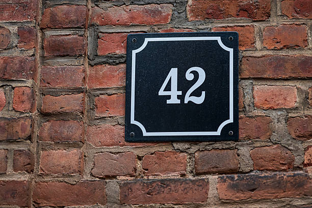 istock House number 42 on brick wall exterior.. 2219529681