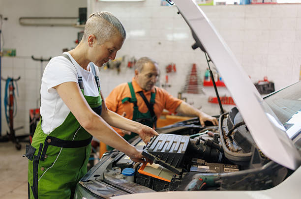 istock Automotive Air Filter Replacement .Man helping his female colleague while working at auto repair shop 2219530847