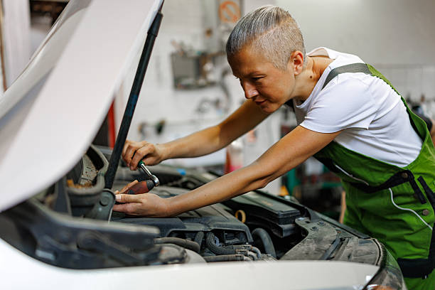 istock Female Mechanic in Overalls Servicing Car Engine 2219532034