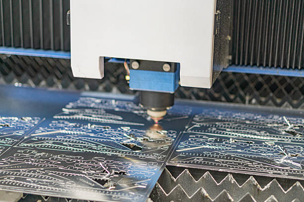 istock Robotic arm moving towards PCBs on an assembly line in industrial environment 2219532070