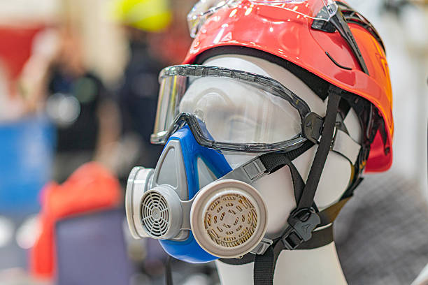 istock Firefighter in protective gear, facing away, indoor setting with warm lighting 2219532209