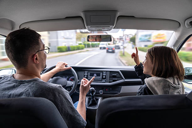 istock City driving. In-car conversation. Child pointing ahead. 2219533385
