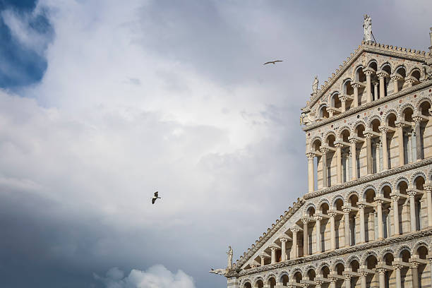 March 2025 -Pisa, Italy: Stormy clouds at Piazza del Duomo, a square with the  Battistero di San Giovanni (baptistery),  the  (leaning ) Tower of Pisa and in the picture the Pisa Cathedral.