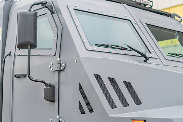 istock Greyblack armored demining vehicle, multiple windowed, protective grilles, outdoor setting, overcast lighting, roadway background, no people or text visible, straightforward photography style 2219533740
