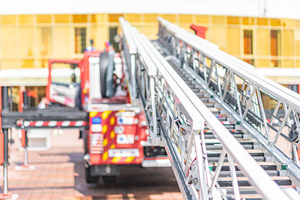 istock Fire truck with extendable ladder on paved surface, red and white, firefighting equipment, natural lighting, outdoor public area 2219534010