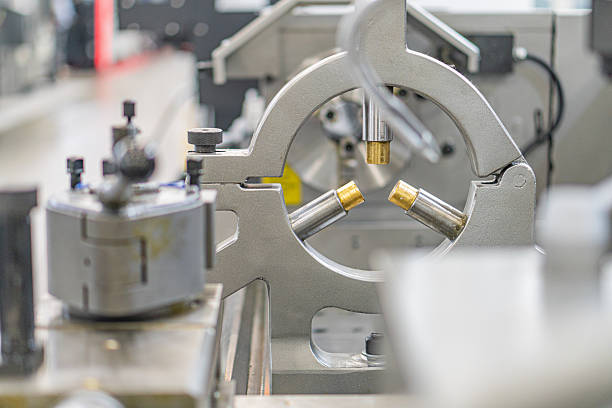 istock A large, gray metallic industrial machine with levers, gears, and mechanical components, situated in an indoor factory setting 2219535082