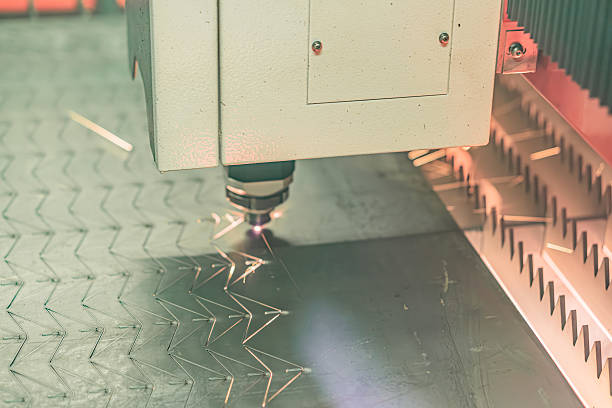 istock Industrial setting, laser engraving machine, metallic object, operation, visible sparks, textured surface, workshop or manufacturing environment, bright lighting, shadows, no texts, realistic style, 2219535206
