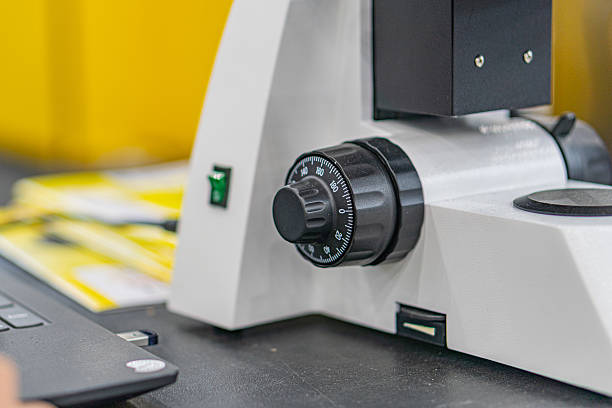 istock Close-up of a complex, angled object with concentric rings and smaller dialsbuttons, possibly plastic or metal electronicmachinery equipment Hint of human activity in the background, industrial se 2219535290