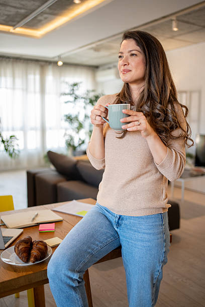 istock Woman enjoying relaxing coffee break at home office 2219543554