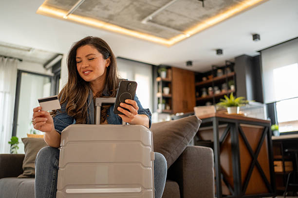 istock Woman booking a trip online using credit card and smartphone 2219543767