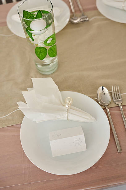 istock Elegant place setting featuring floral decor and personalized card on table 2219545160