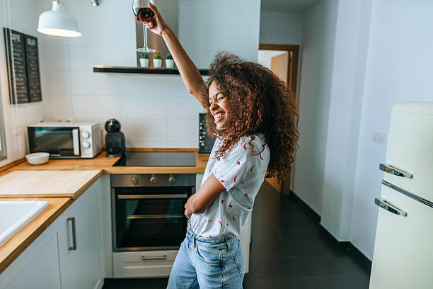 istock Woman dancing in the kitchen while drinking Sherry wine 2219545456