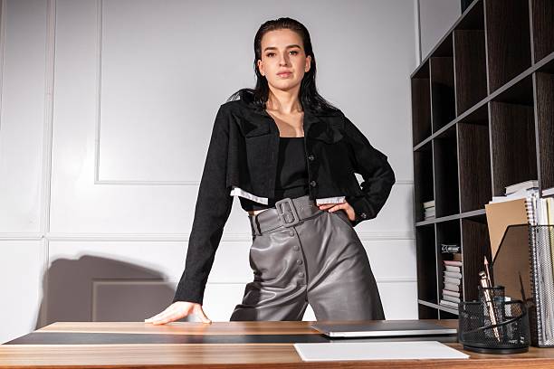 istock Stylish professional woman posing confidently at a modern office workspace during daylight 2219546143